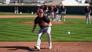 baseball player in a field with teammates behind
